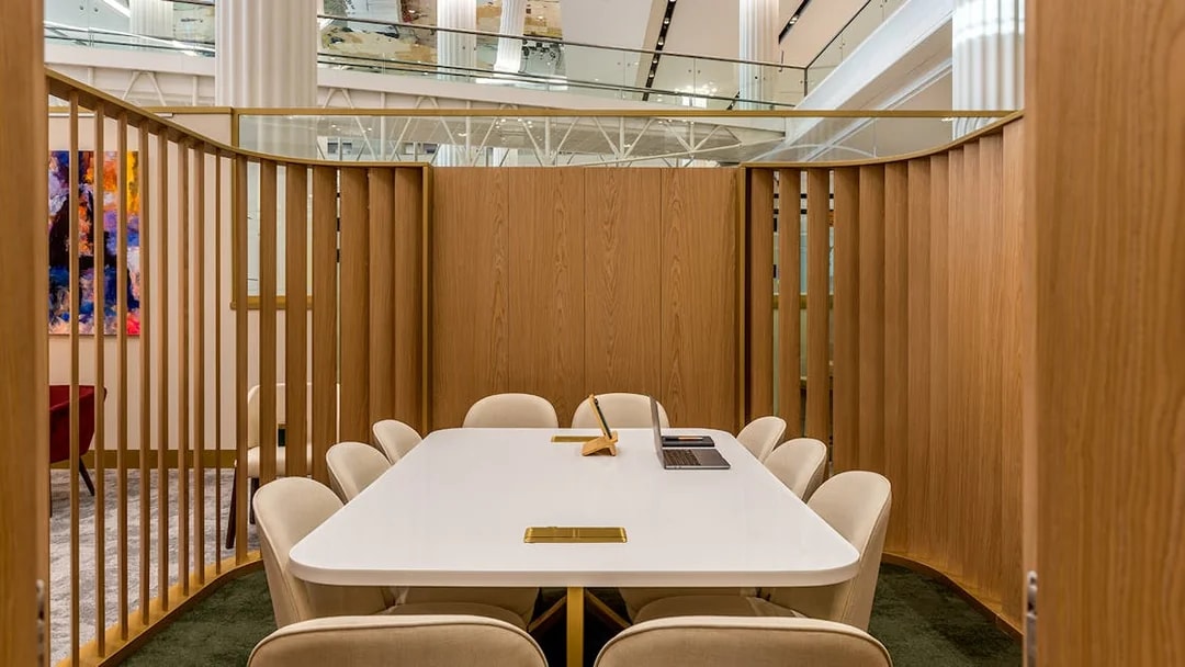 Premium lounge seating area at Dubai International Airport (DXB) with a conference table.