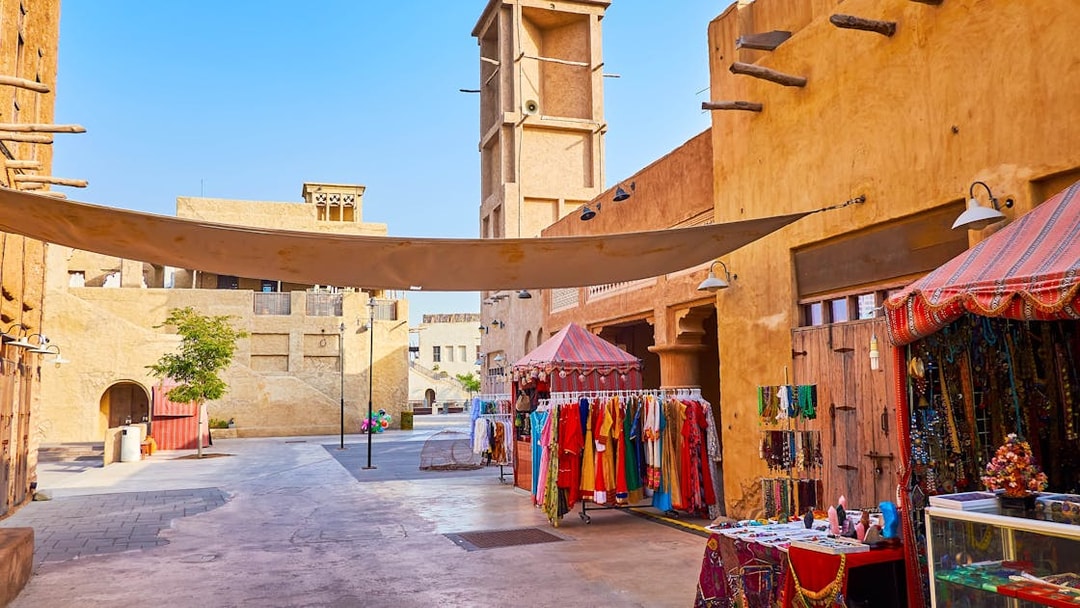 Heritage Village market stalls with traditional clothing and crafts in Dubai.