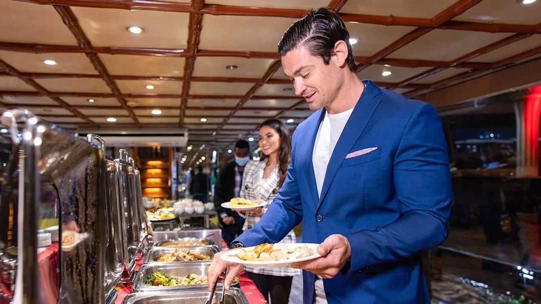 Guests serving themselves from a buffet on the Luxury Dhow Cruise.