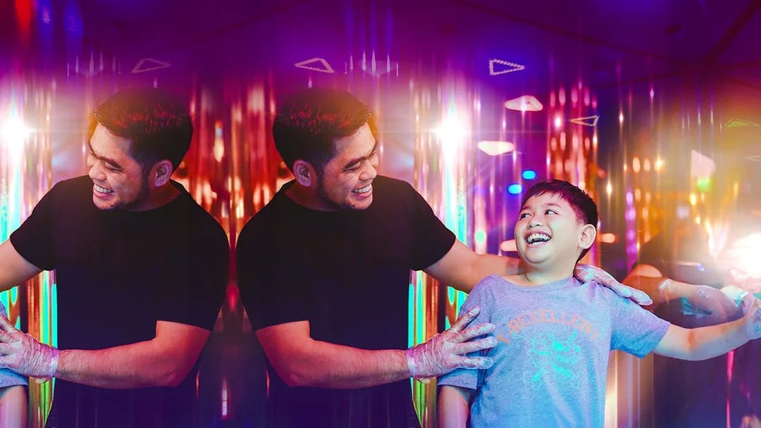 Tourists enjoying a colorful mirror maze experience.