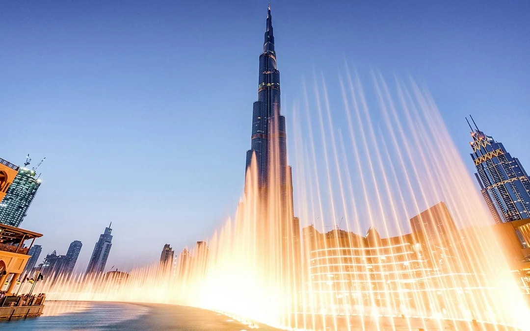 Dubai Fountain Boardwalk with Burj Khalifa in the background at dusk.