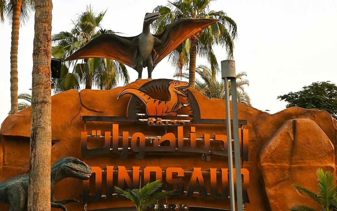 Dinosaur Park entrance sign with pterodactyl statue at Dubai Garden Glow.