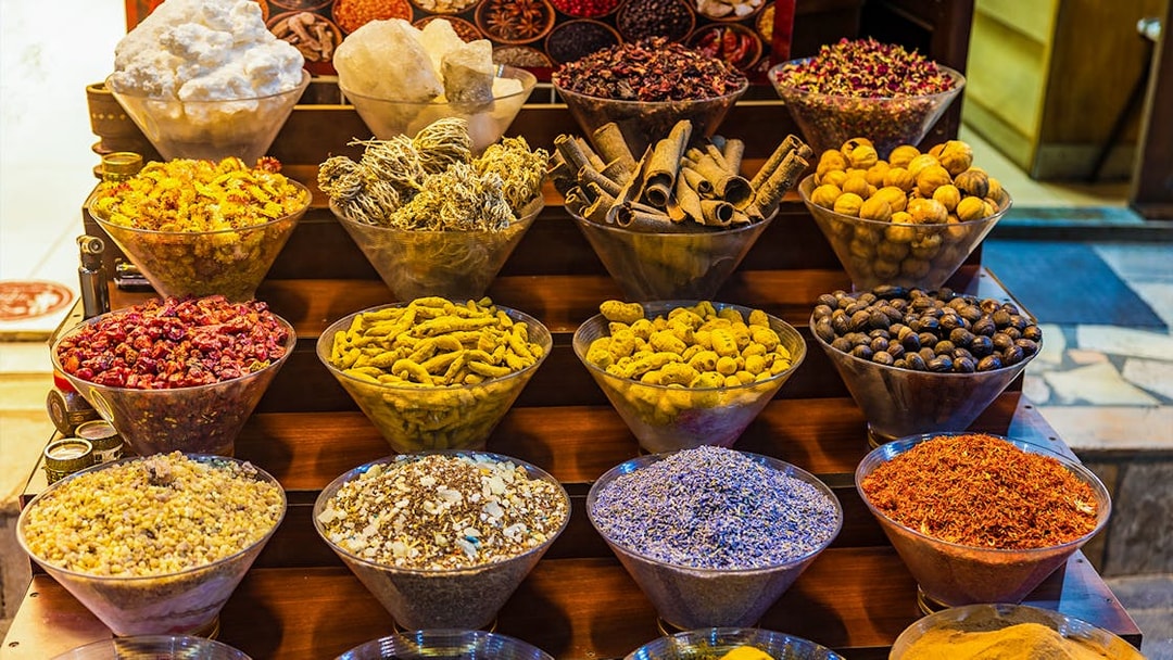 Spices displayed in bowls at a market in Dubai during a half-day sightseeing tour.