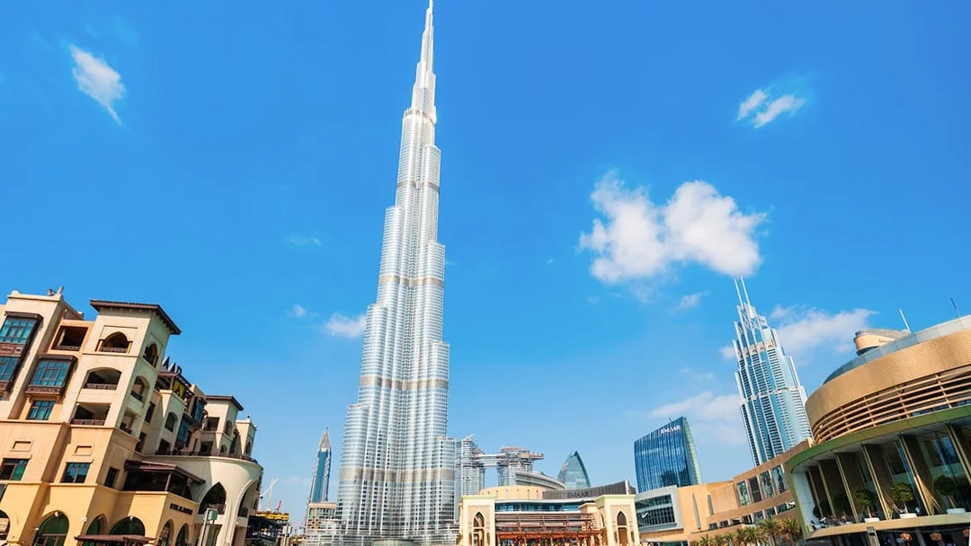 Burj Khalifa towering over Dubai cityscape on a clear day.