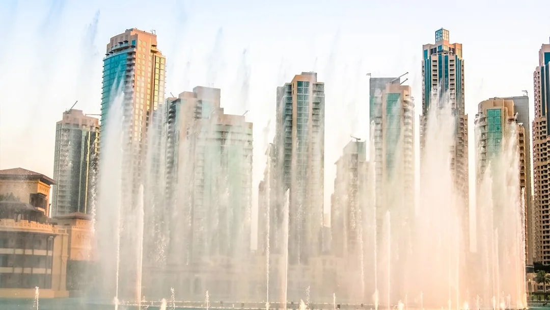 Dubai Fountain show with skyscrapers in the background during a half-day sightseeing tour.