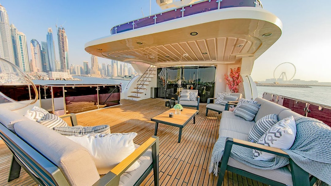 Superyacht TriDeck cruise deck with seating area overlooking Dubai skyline.