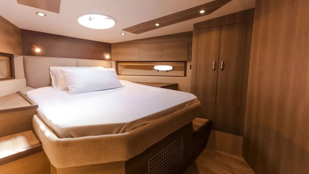 Interior cabin of Viktoriia Luxury Yacht with bed and wooden furnishings.