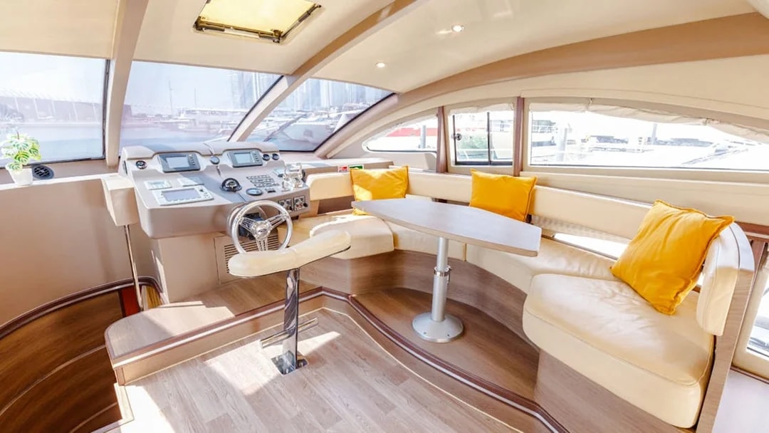Interior of VERONIKA Private Luxury Yacht with helm, seating, and large windows.
