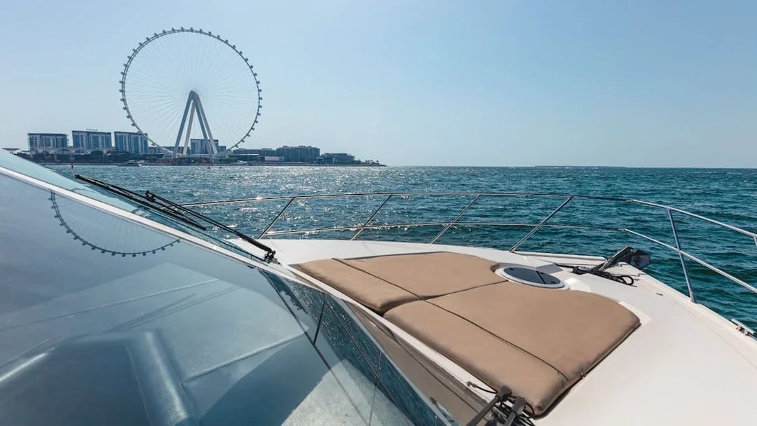 Viktoriia Luxury Yacht with Dubai Ferris wheel in the background on the water.