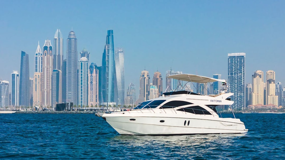 Viktoriia luxury yacht sailing with Dubai skyline in the background.