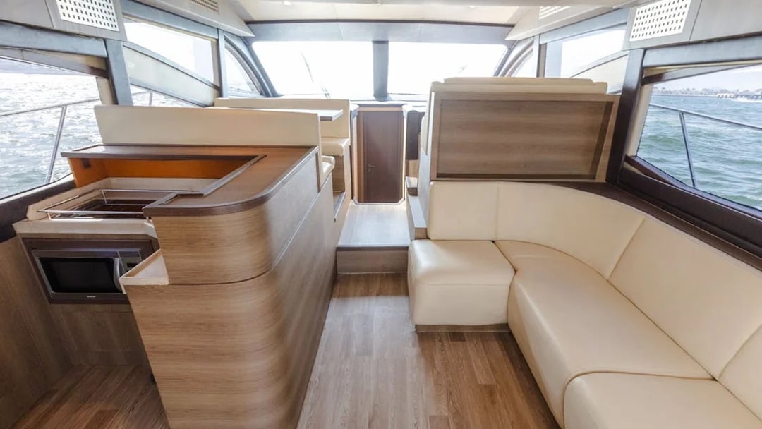 Interior of Viktoriia Luxury Yacht with seating and kitchenette.
