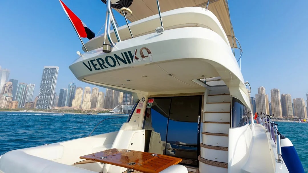Private yacht deck with Dubai Marina skyline in the background.