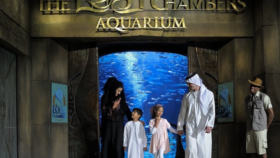 Family exploring Atlantis The Lost Chambers Aquarium entrance, Dubai.