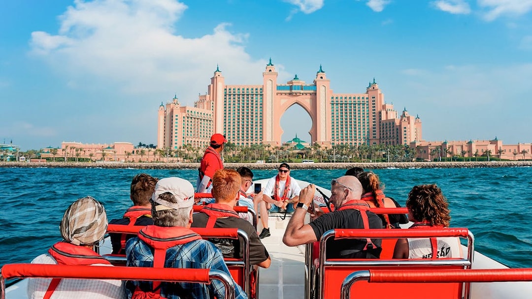Speedboat tour group approaching Atlantis, The Palm in Dubai Marina.