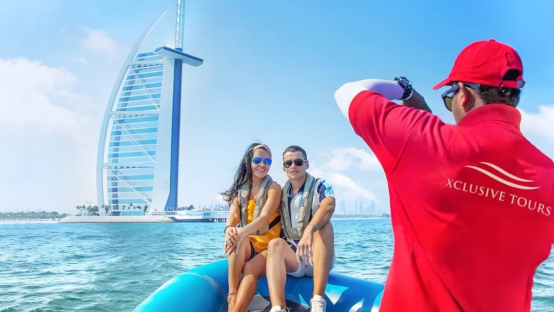 Couple on speedboat near Burj Al Arab during Dubai Marina tour.