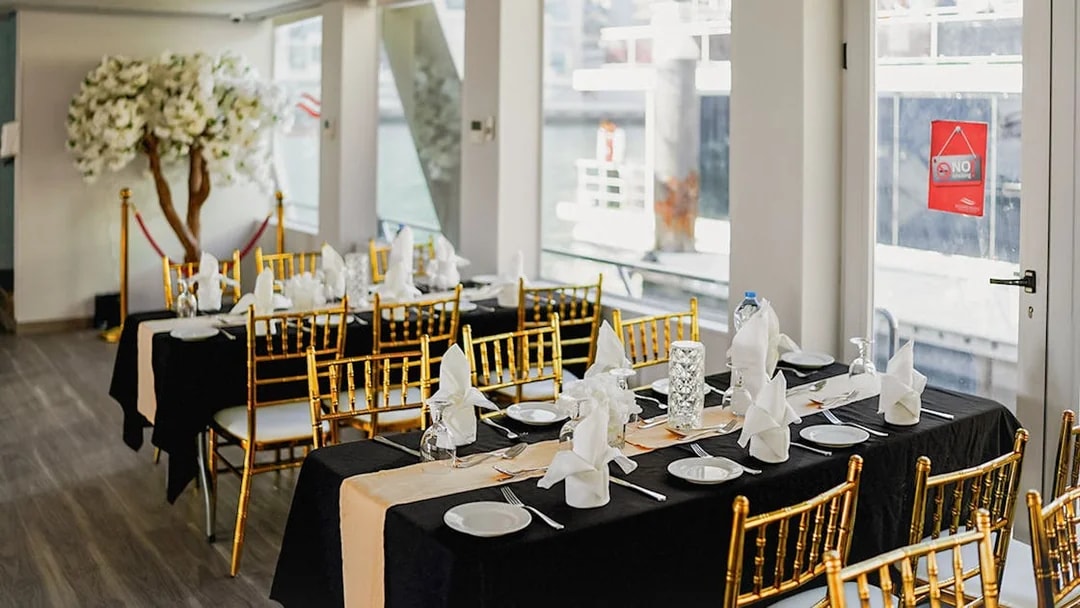 Elegant dining setup on Dubai Marina sunset cruise with buffet dinner.