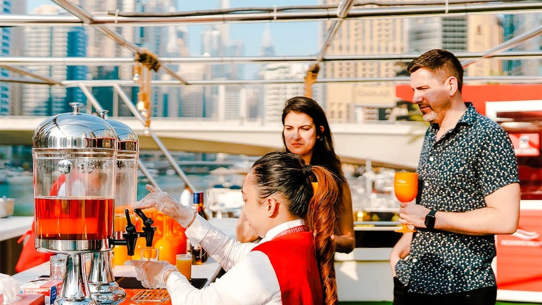 Visitors enjoying drinks on a Dubai Marina sunset cruise.