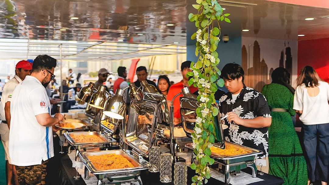 Buffet dinner setup on a sunset cruise in Dubai Marina.