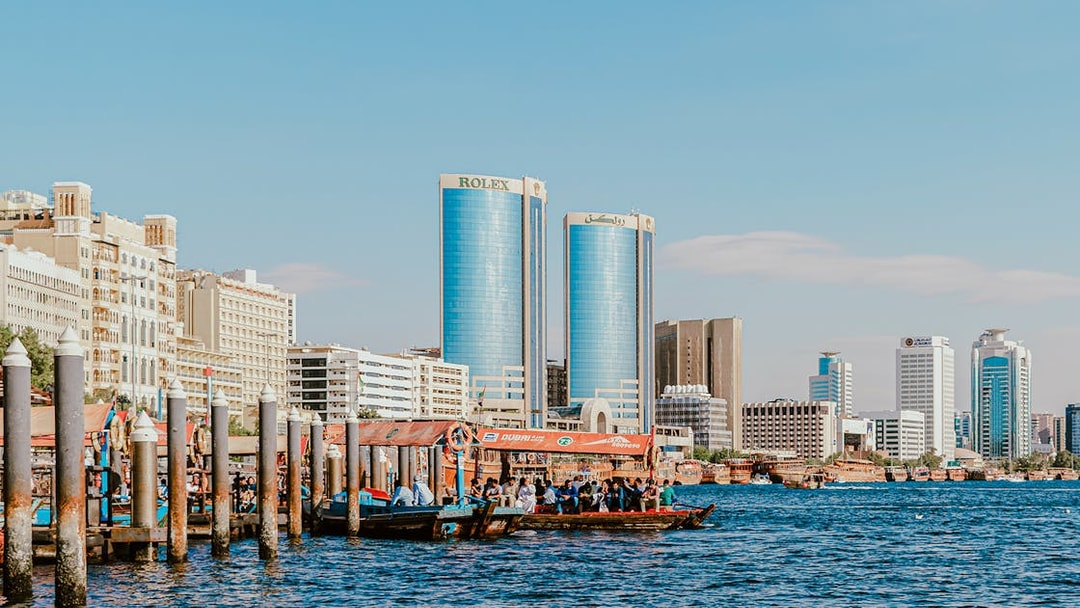 Dhow cruise on Dubai Creek with Rolex Towers in the background.