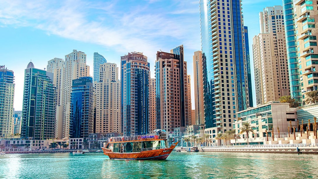 Dhow cruise on Dubai Creek with city skyline in the background.