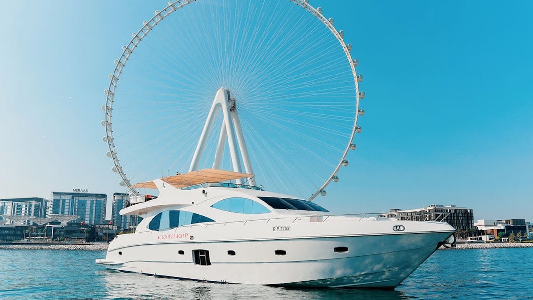 Bluewater yacht with Ain Dubai Wheel in the background on a sunny day.