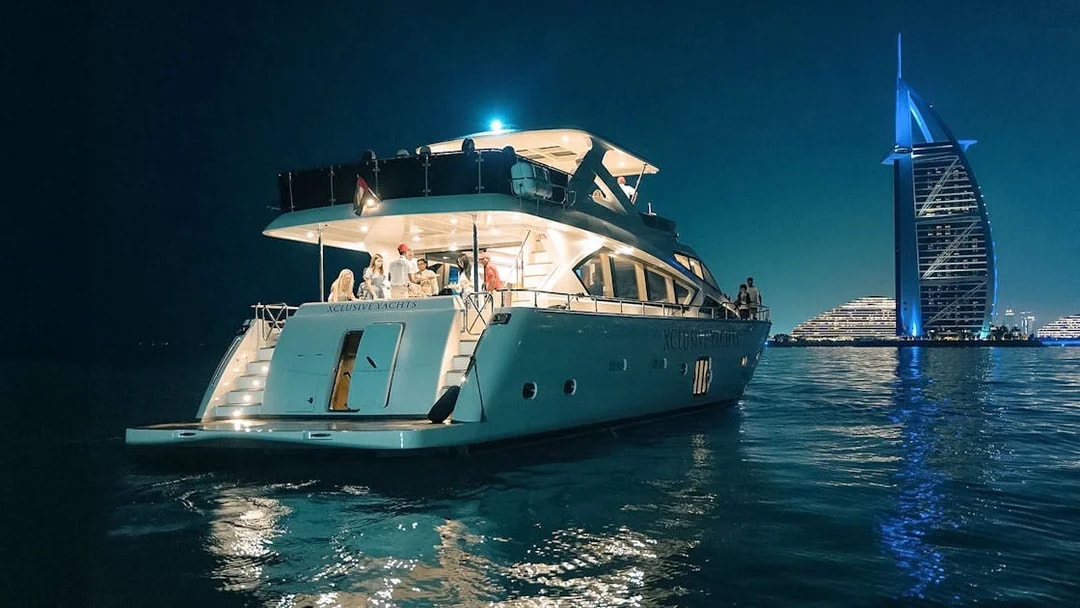 Luxury yacht cruise at night near Burj Al Arab, Dubai.