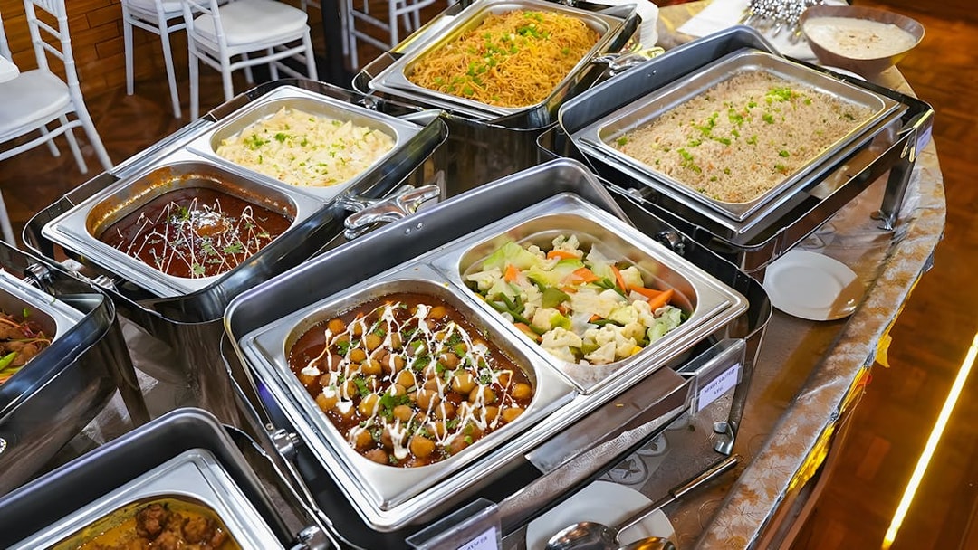 Buffet dinner spread on a Dubai Marina dhow cruise with various dishes.