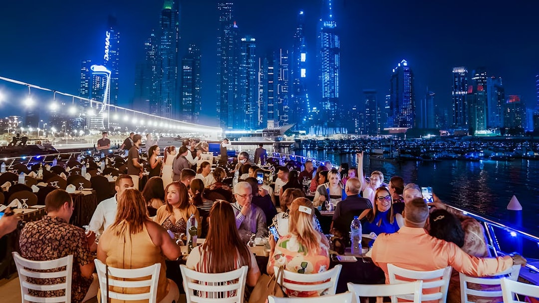 Dining on a luxury dhow cruise with city skyline views, Dubai.