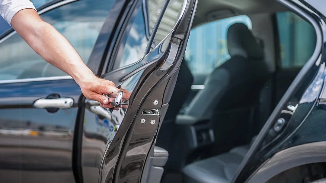 Car door being opened for private airport transfer at Budapest Airport.