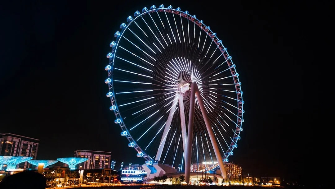 Ferris wheel illuminated at night on Bluewaters Island, Dubai.