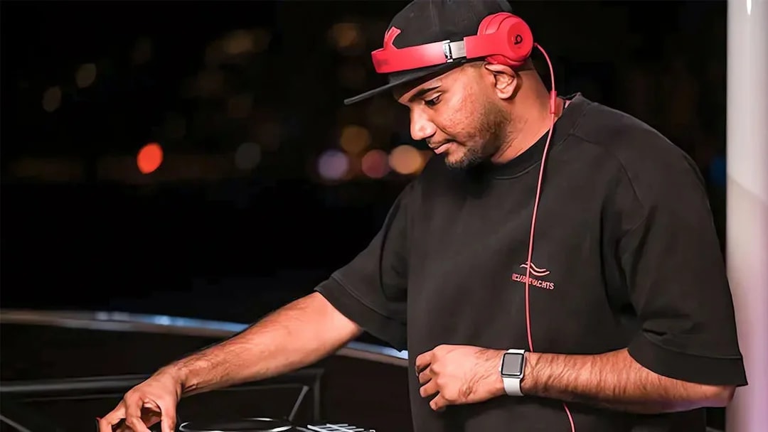 DJ performing on a party yacht cruise at night.