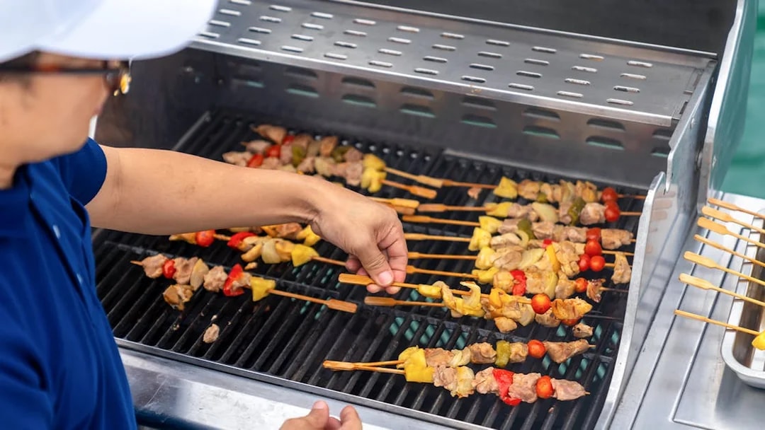 Grilling skewers with vegetables and meat at Dubai Marina yacht party BBQ.