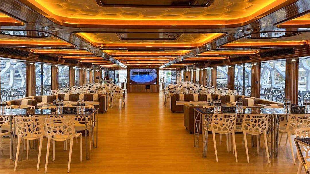Luxurious dining area on Lotus Mega Yacht in Dubai Marina with tables set for buffet dinner.