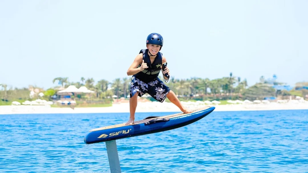 Kid efoil surfing on blue water in Dubai.