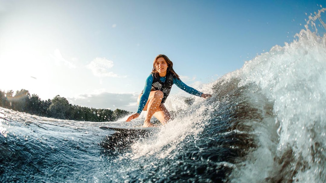Woman wakeboarding on a wave in Dubai.