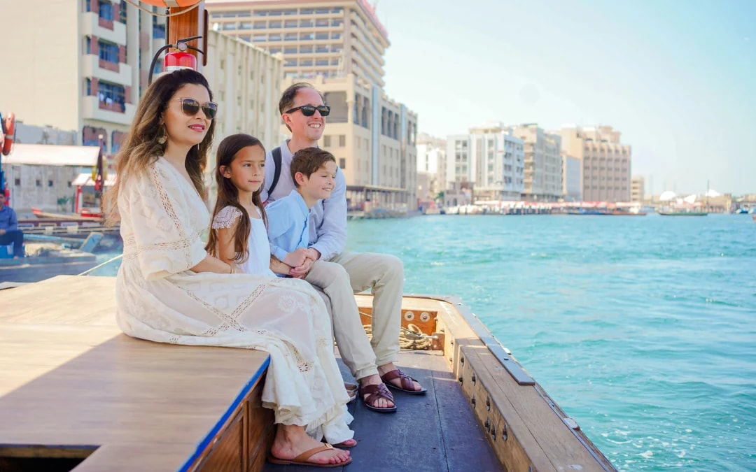 Family enjoying a ride on a traditional abra in Dubai Creek.