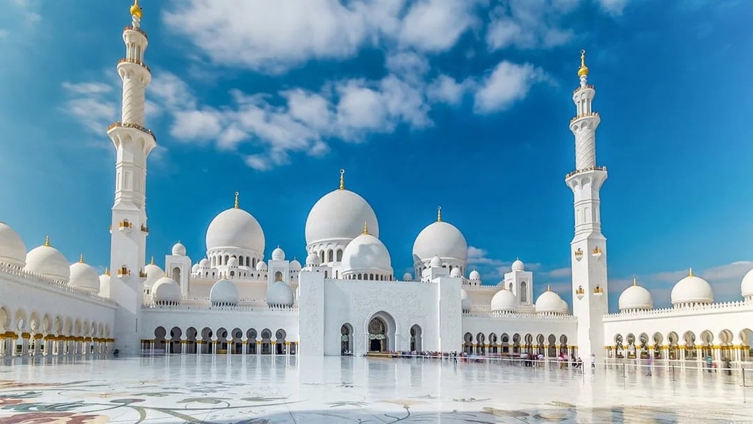 Sheikh Zayed Grand Mosque domes and minarets under blue sky, Abu Dhabi city tour.