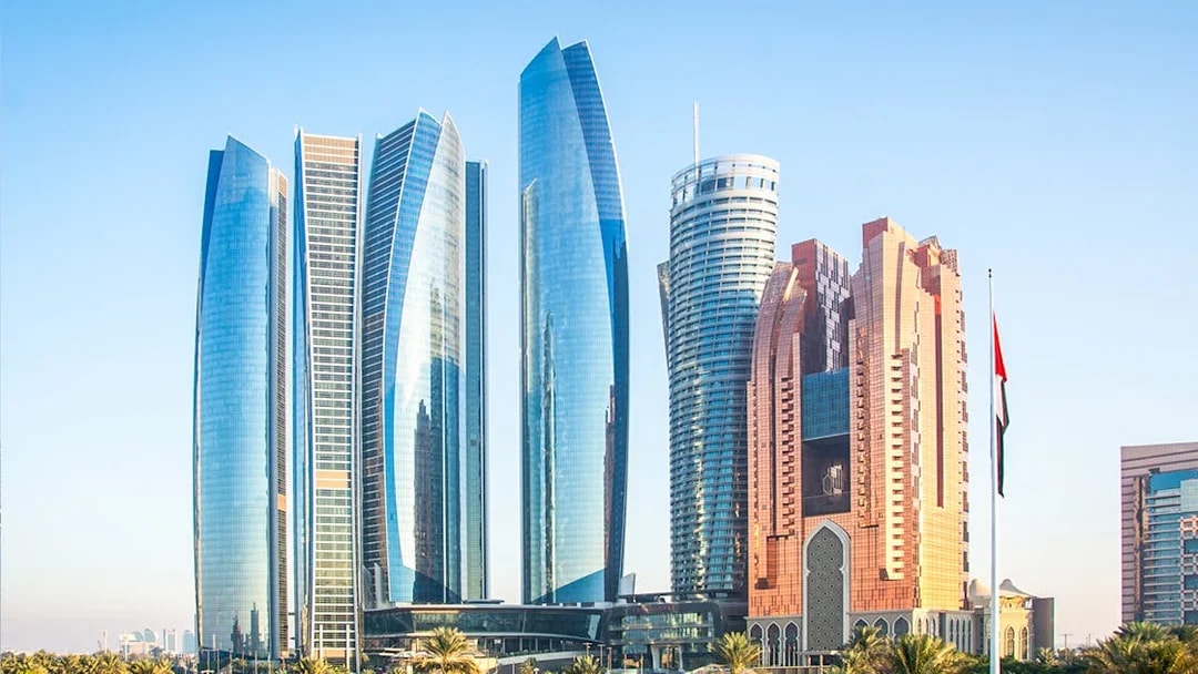 Etihad Towers skyline in Abu Dhabi with modern architecture and palm trees.