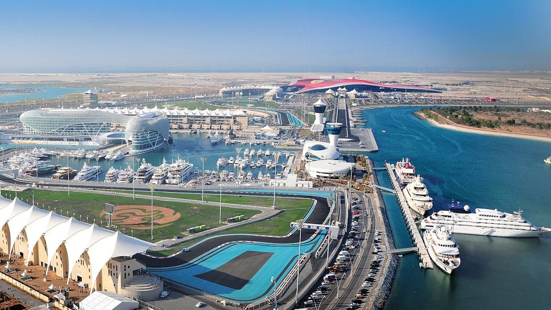 Yas Marina Circuit aerial view with yachts and racetrack in Abu Dhabi.