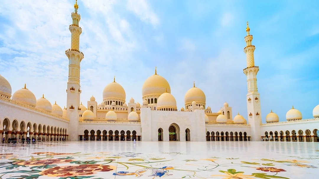 Sheikh Zayed Grand Mosque courtyard in Abu Dhabi with floral marble design.