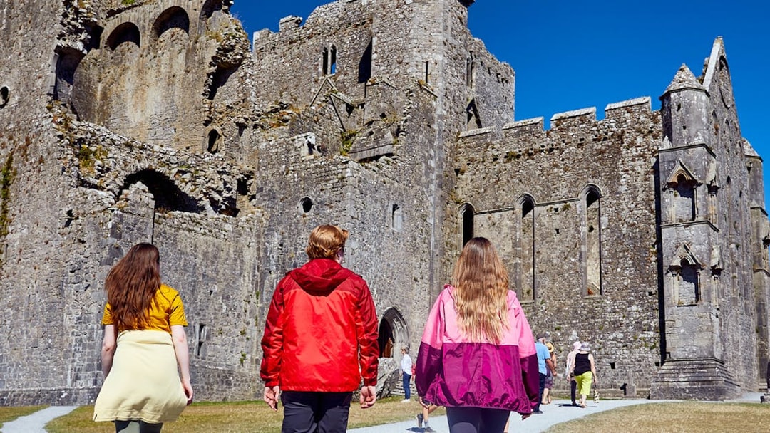 Tourists walking towards Blarney Castle in Ireland.