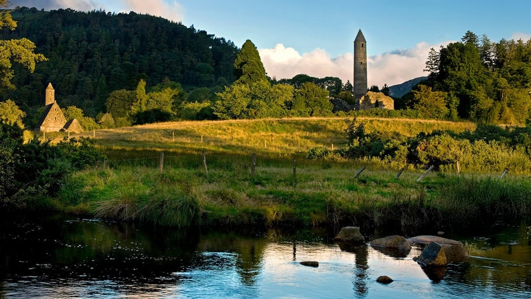 Wicklow National Park with ancient stone tower and lush green landscape.