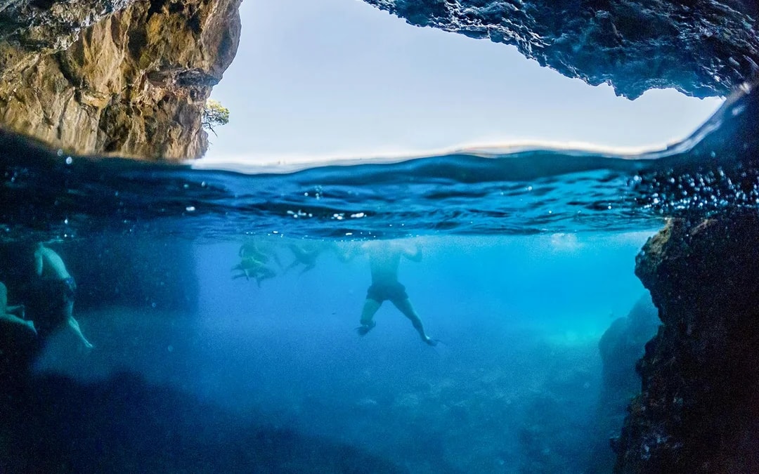 Snorkelers exploring underwater cave near Dubrovnik.