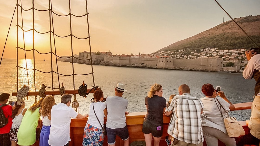 Guests viewing Dubrovnik's city walls on Karaka Ship sunset cruise.