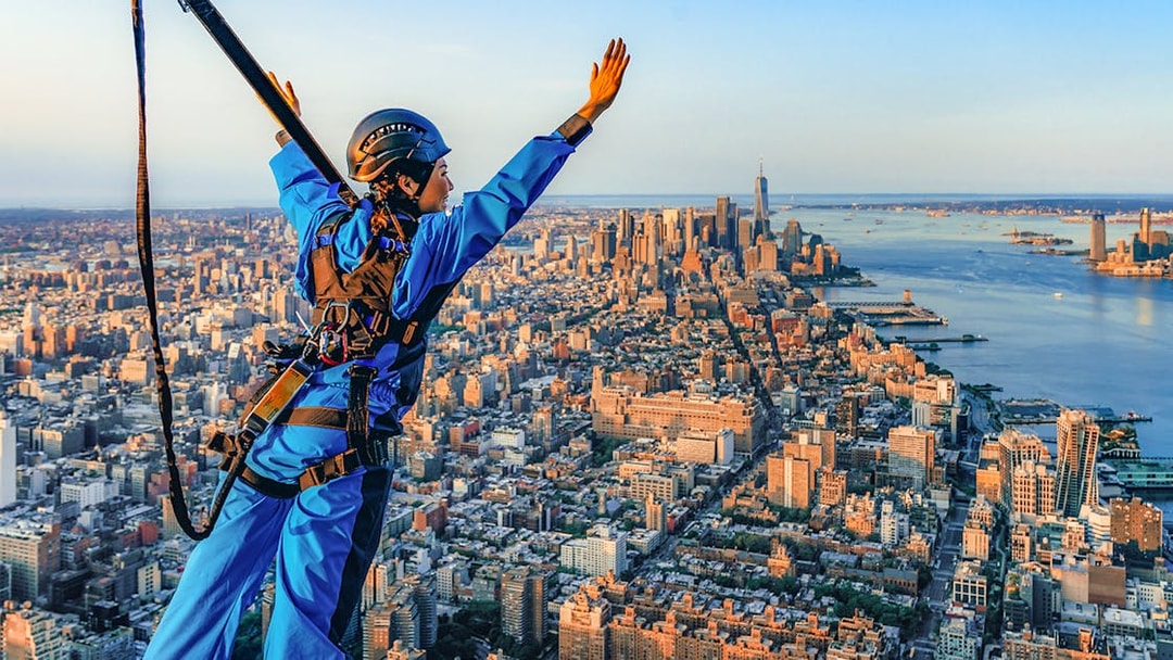 Person in harness enjoying view from skyscraper in New York City with Edge Express Pass.