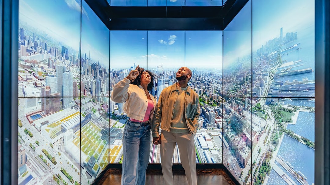 Couple enjoying city skyline view at Edge observation deck in New York City.