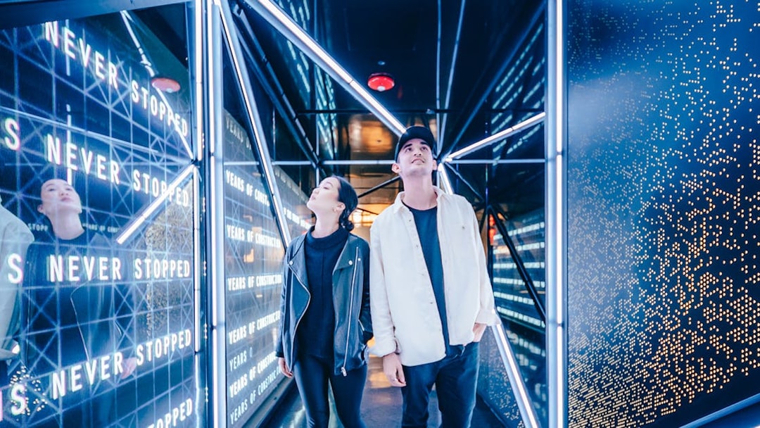 Visitors exploring the illuminated hallway at the Edge Observational Deck in NYC.