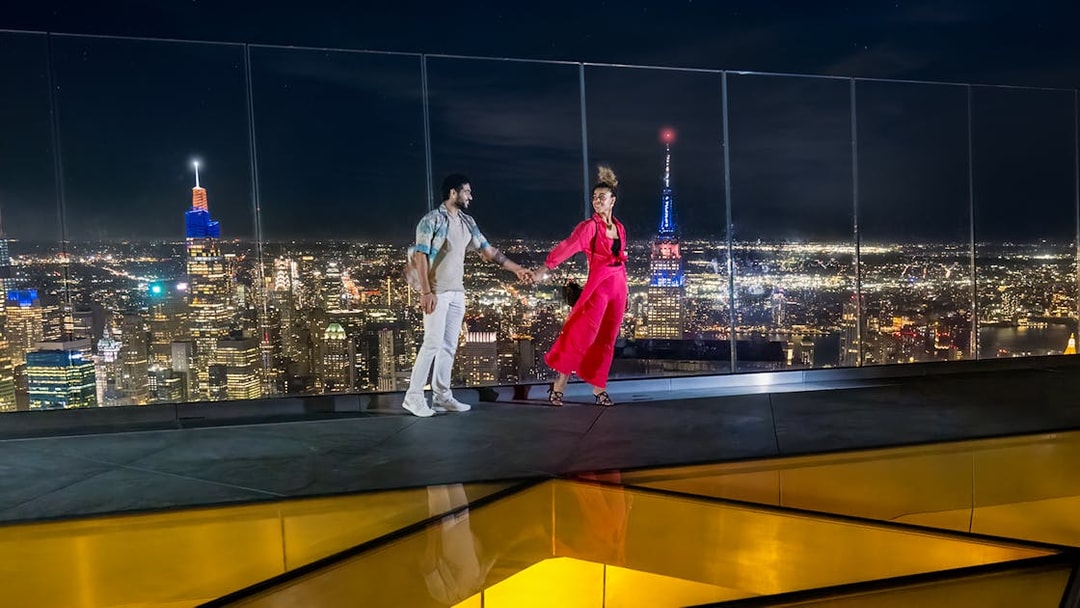 Couple enjoying night view from Edge Observation Deck, New York City.