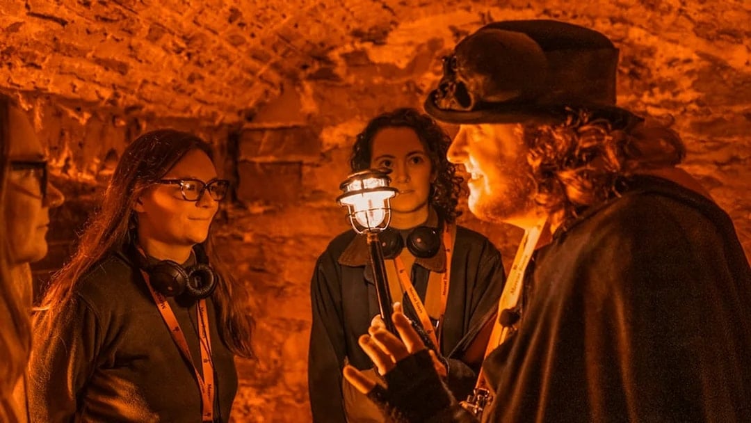 Guide leading a group through Blair Street Underground Vaults.