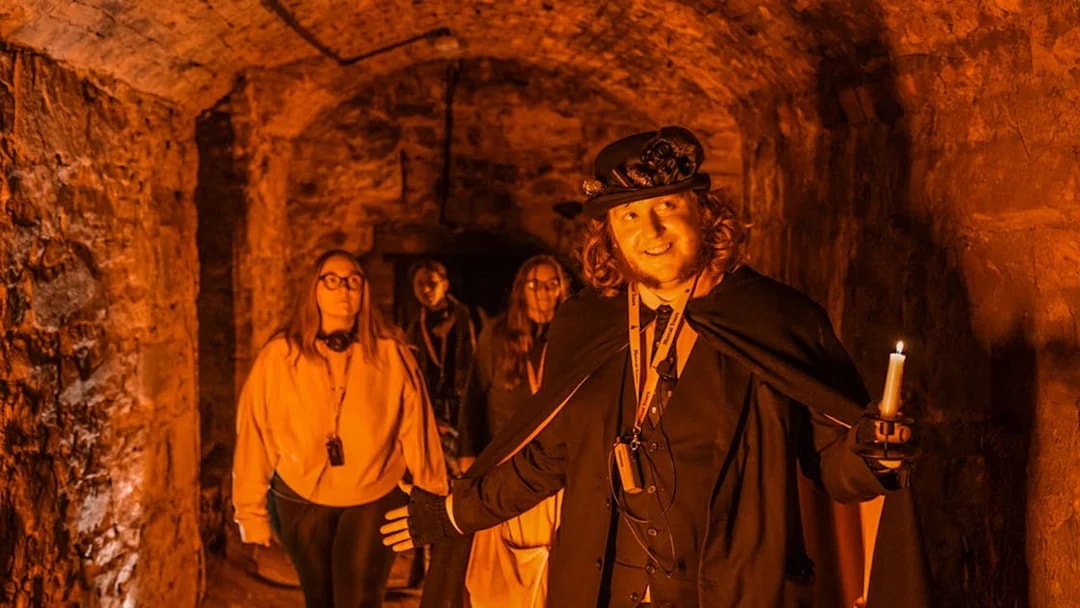 Tour guide leading a group through Blair Street Underground Vaults.